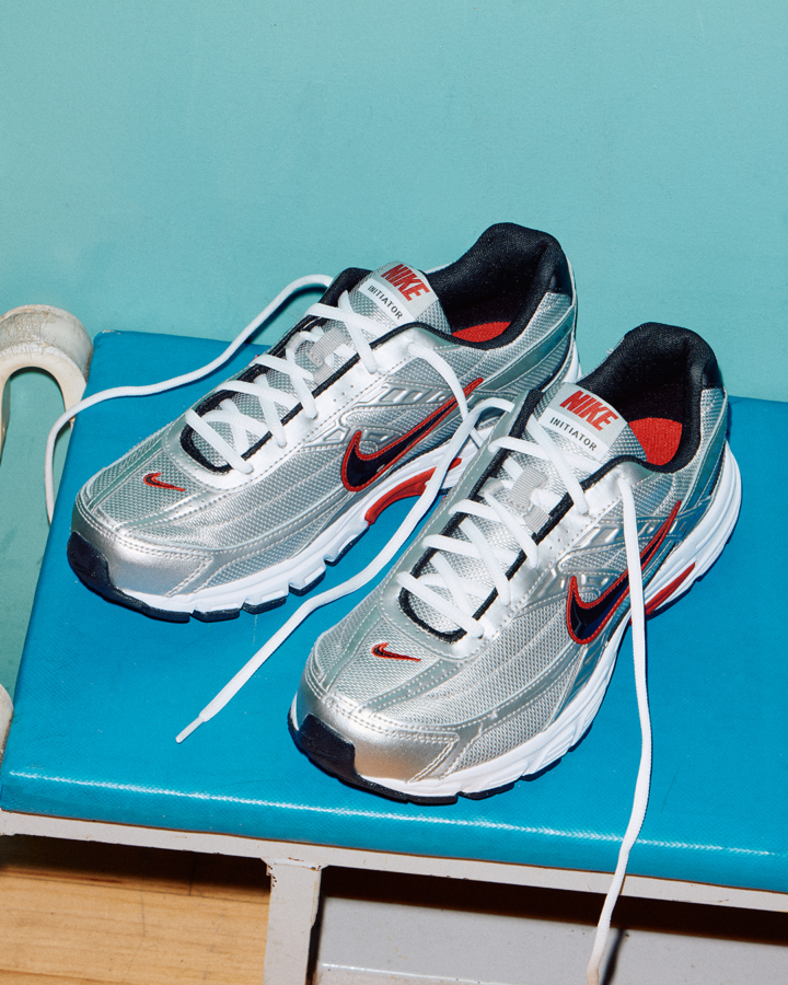 Nike Initiator trainer in silver with red and black details.