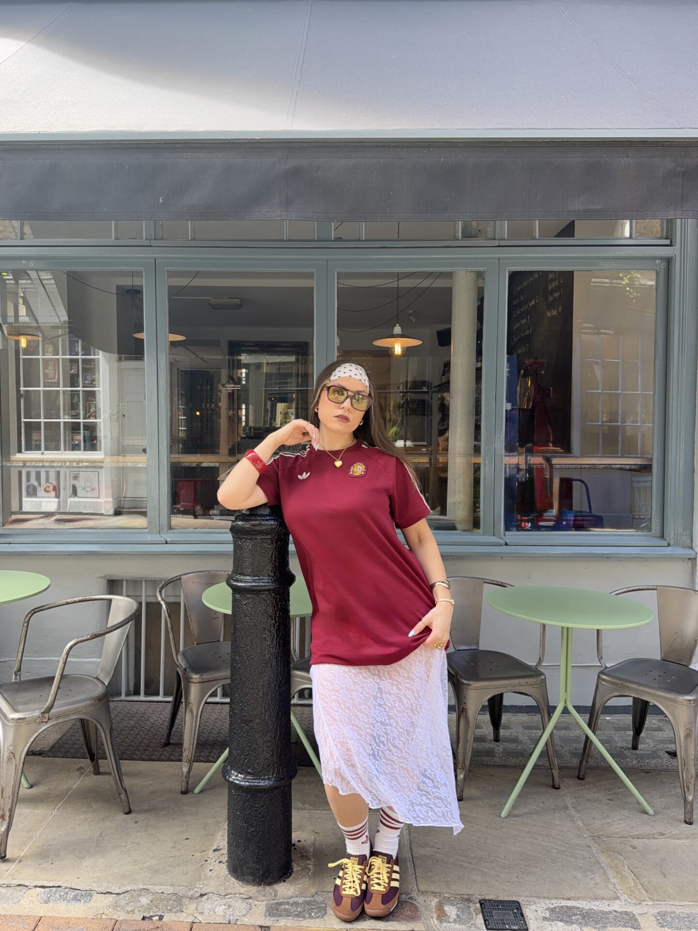 @sorrelwj wearing the brown adidas SL 72 with white and red adidas socks, a white lace skirt, and a red Spain football top.