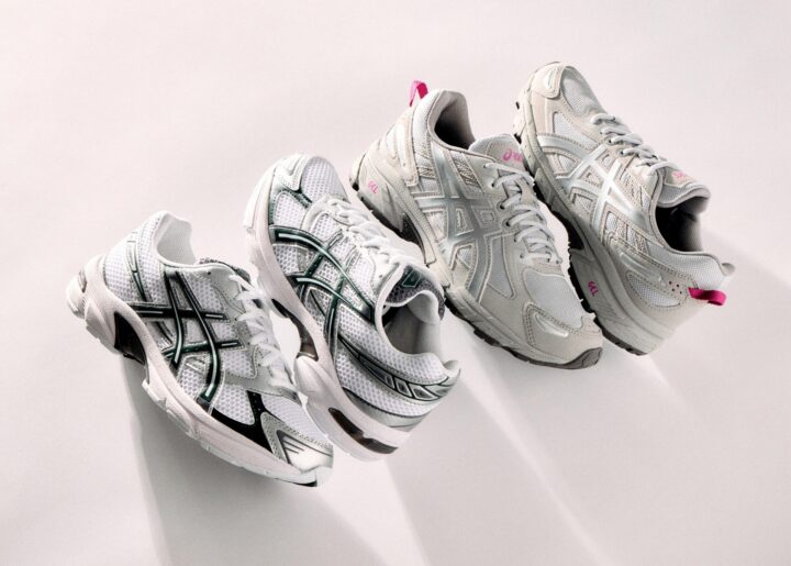 Two pairs of white ASICS trainers.