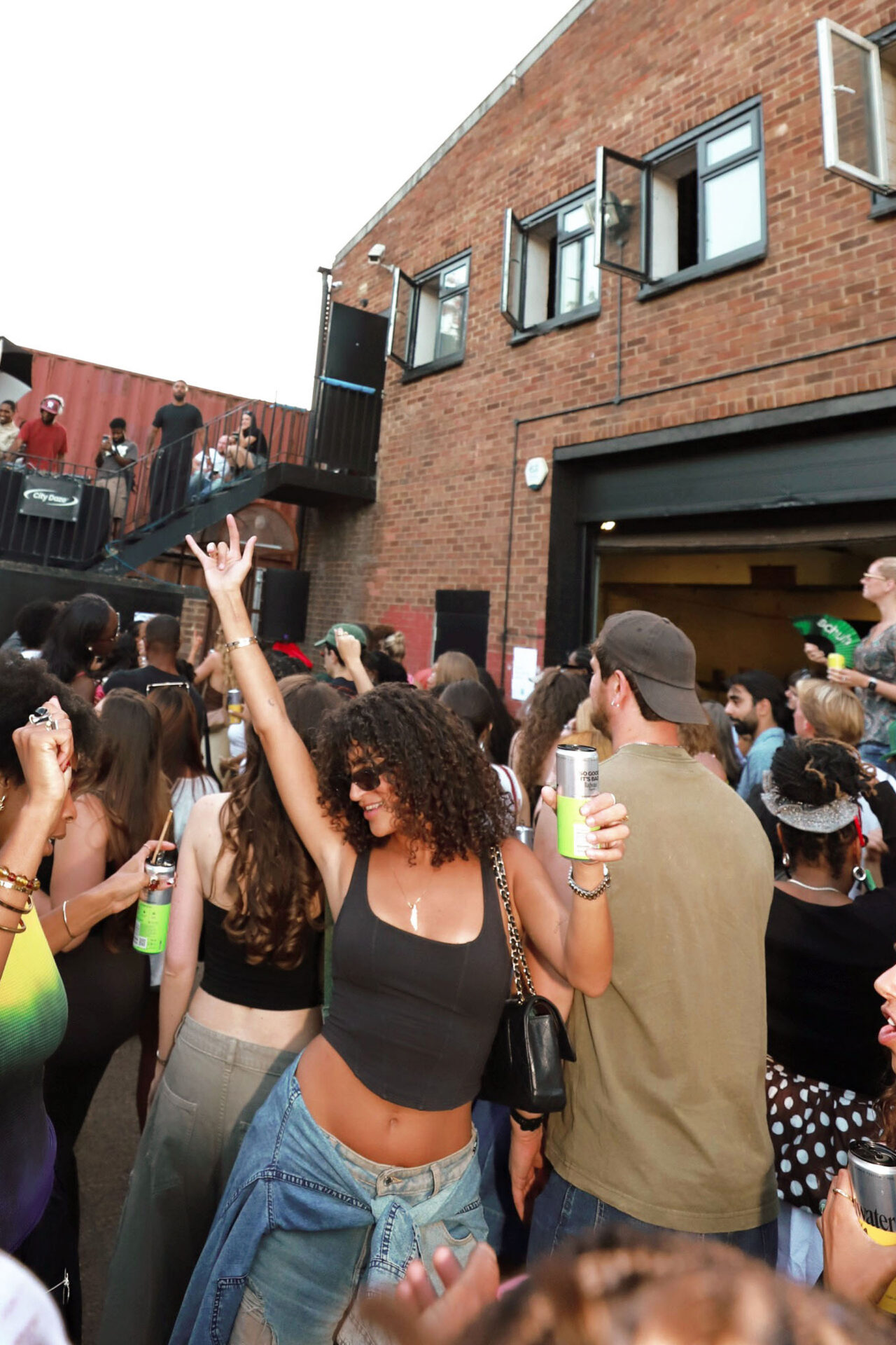 A schuh x City Daze Summer Block Party attendee dancing in the crowd.